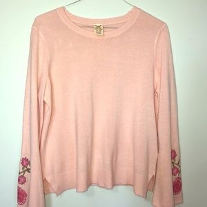 Pink sweater with embroidered flowers on sleeves